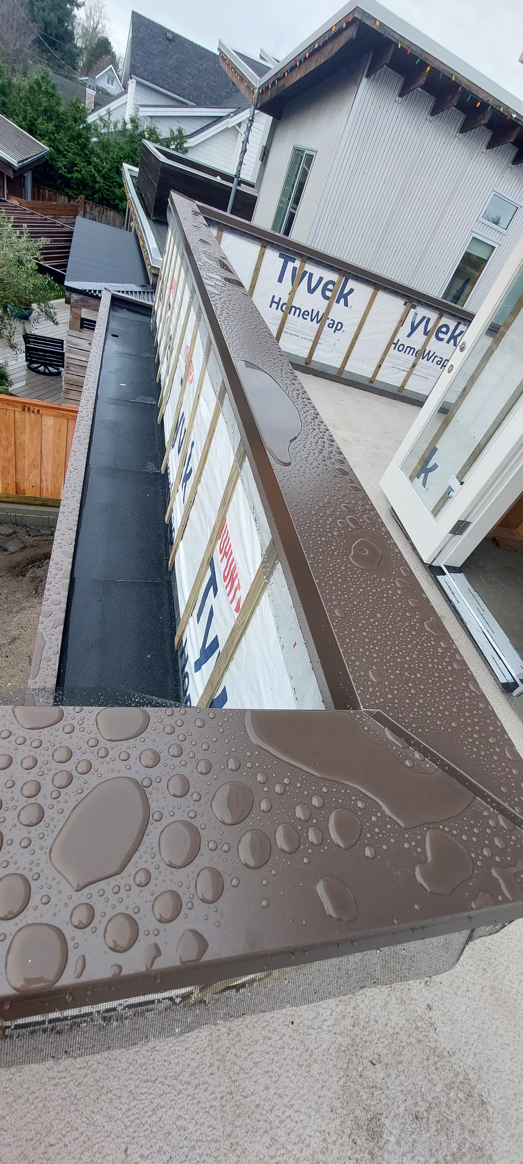 Completed metal flashing system protecting exterior envelope by Tomron Construction in Maple Ridge, BC